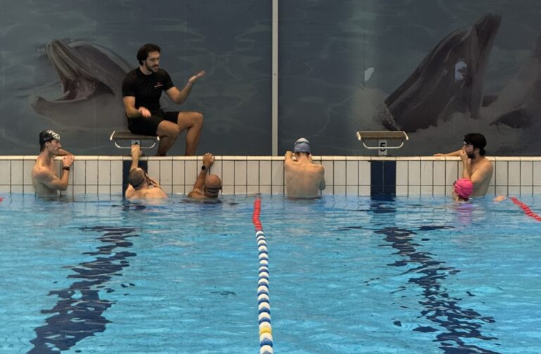 Adults practising front crawl during swimming lesson in Amsterdam pool